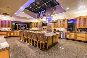 large open kitchen with ambient lighting and large table with chairs