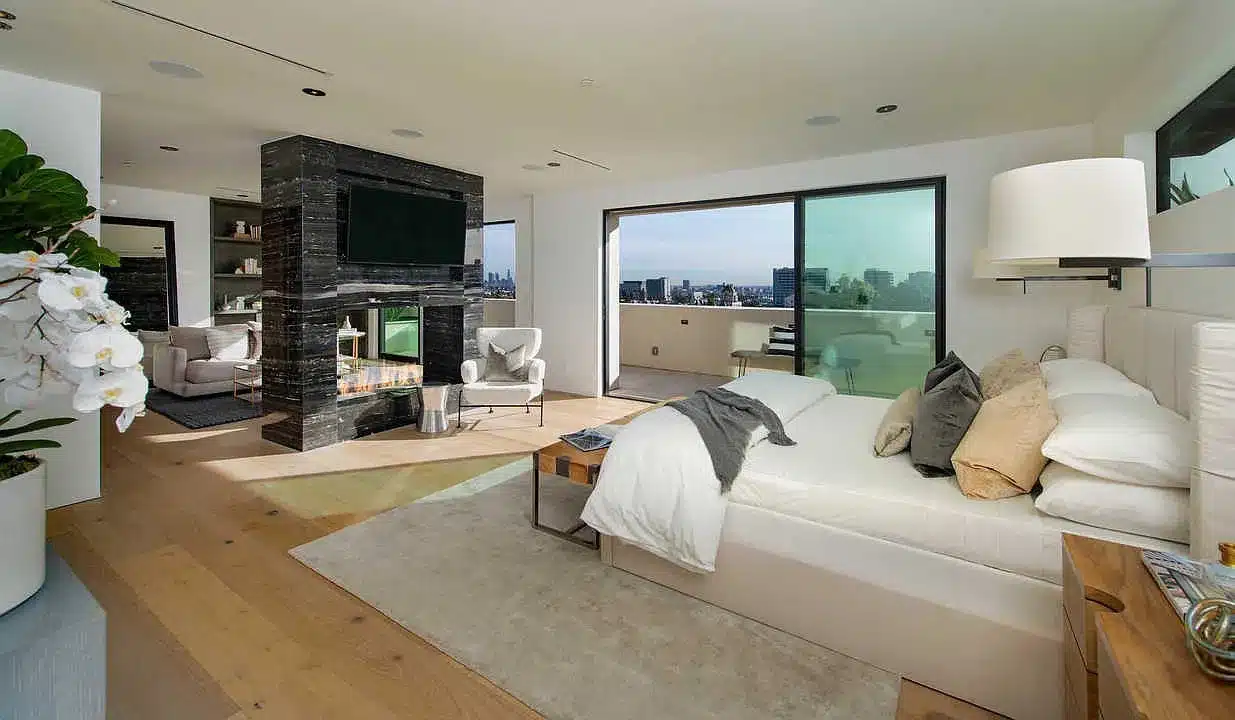 vine luxury bedroom with fireplace and view